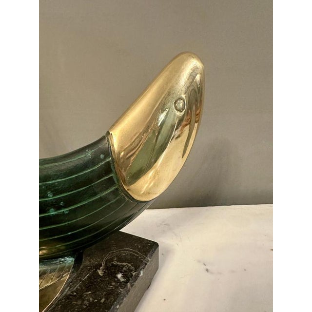 A Continental fish sculpture in verdigris patinated bronze and brass supported on a black fossil marble base. Nice scale,...