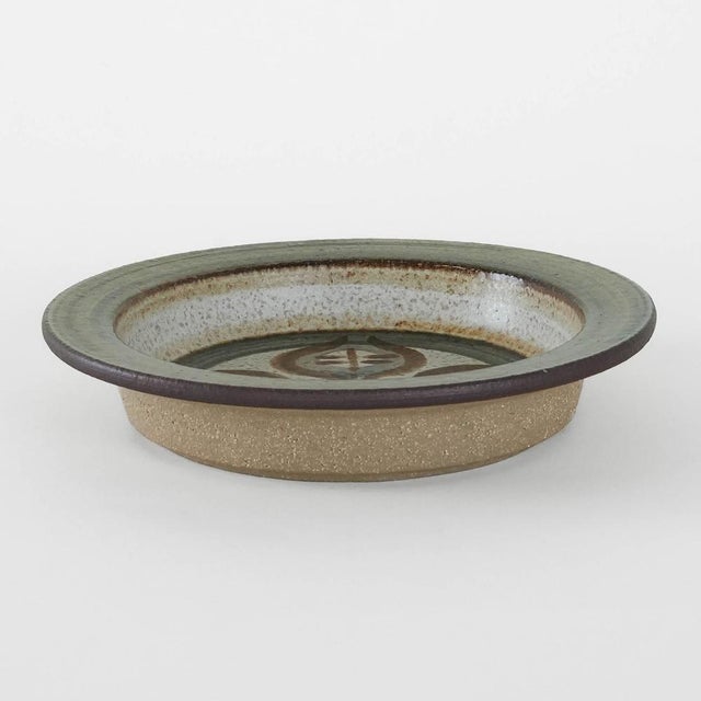 A ceramic bowl manufactured in the 1960s by the Danish manufacturer Søholm. It features natural colors of beige, brown,...
