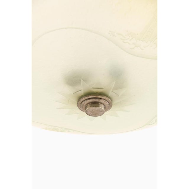 This ceiling lamp or flush mount, produced in Sweden during the 1940s, is a notable example of early Scandinavian lighting...