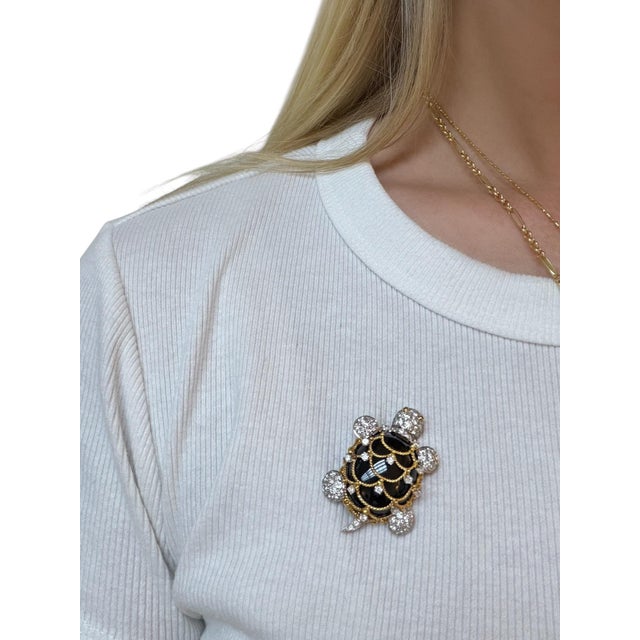 This whimsical turtle brooch by Hammerman Brothers consists of an onyx body with twisted rope detail set with round...