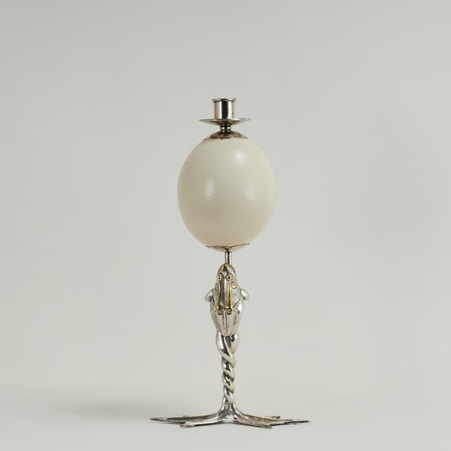 Whimsical yet sophisticated pair of candlesticks having a surprising composition with ostrich eggs held by frogs supported...