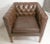 Unusual shape arm chair with tufted inside back and sides. Sharp square lines, wood legs and brass nail trim. (Please...