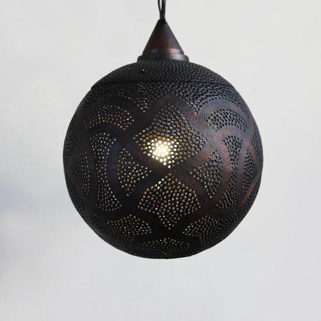 Antiqued copper globe lantern with perforated moorish design patterns that shine beautiful patterns onto walls and...
