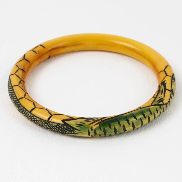 A stunning 1910s French Art Nouveau Celluloid bracelet bangle. The piece features a hand-carved lizard design. The...