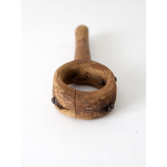 This is a vintage primitive tool. The handmade tool consists of wood with four screws inserted into a circular top. This...