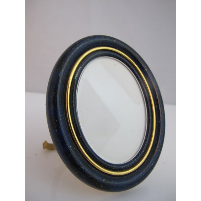 Vintage, 1980's Les Must de Cartier Paris oval picture frame. Gilt-plated metal base decorated with a blue enamel lacquer...