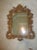 Stunning gold ornate mirror with hanging hardware attached.
