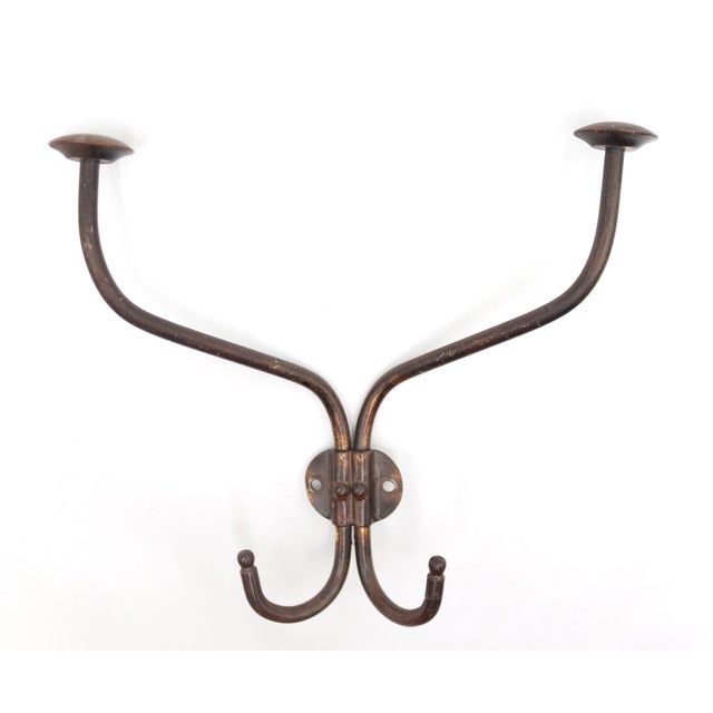 Vintage wall hook made of a dark brass finish steel. The original mounting screws are not available. Good condition with...
