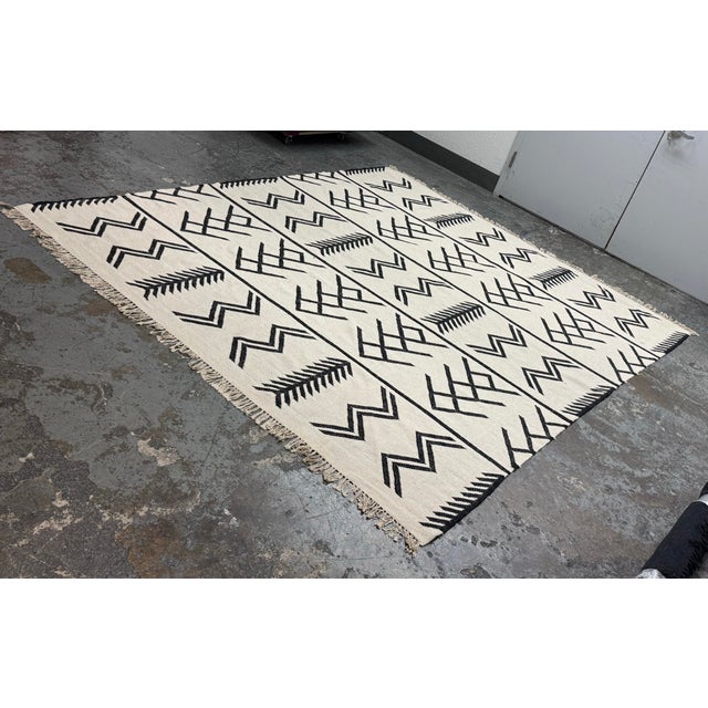Design Plus Gallery presents a 8 ft 2 in × 9 ft 9 in Coulter Graphic Wool Area Rug from Four Hands. This area rug...