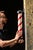 Antique barbershop pole with porcelain caps and a milk glass staff. This piece features the classic barber pole design...