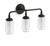 Classic, vintage-inspired Artifacts 3-light wall sconce/vanity light in matte black with clear glass bell shades and inner...