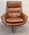 A Mid Century Modern lounge chair and ottoman from Sweden. Marrying form and function, this ensemble boasts a swiveling...
