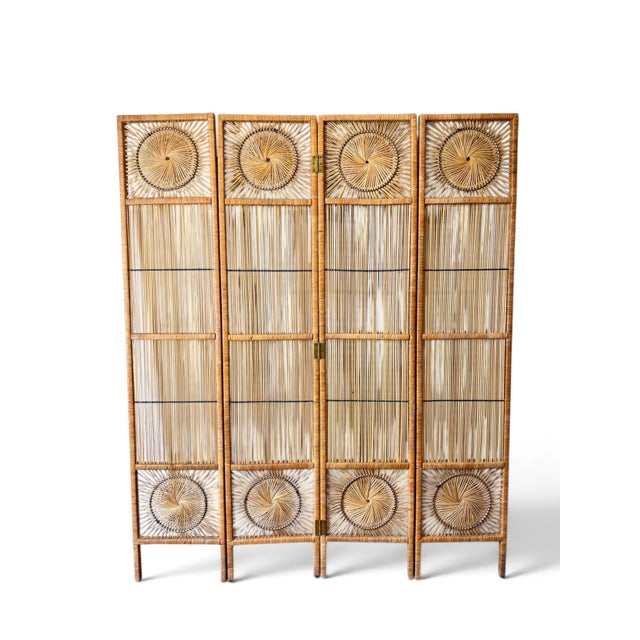 A vintage mid-century modern four-panel room divider screen handcrafted from woven rattan with brass hinges. Each panel...