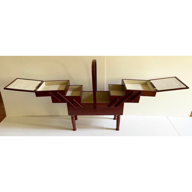 Three level mid-century style wooden accordion folding sewing storage basket. Dark wood box with metal hardware box has 3...