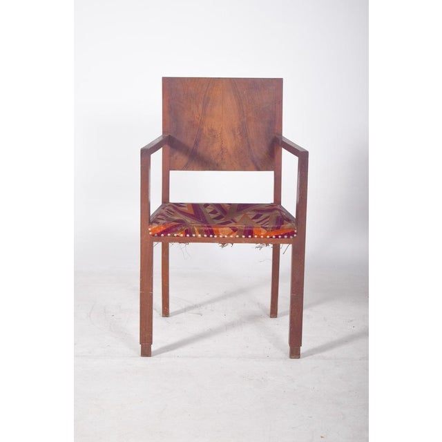Armchair with fabric upholstery. Robust structure with straight lines and a simple finish, harking back to the functional...