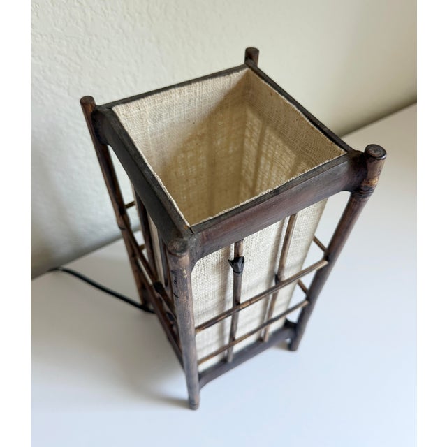 A vintage Louis Sognot-style lantern table lamp crafted from a bamboo outer frame and an interior textile shade. Sognot...
