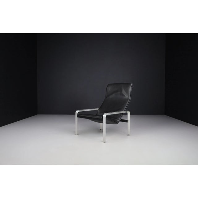 Matteo Grassi black leather lounge chair, Italy 1970s. It is constructed of a metal frame covered with thick black saddle...