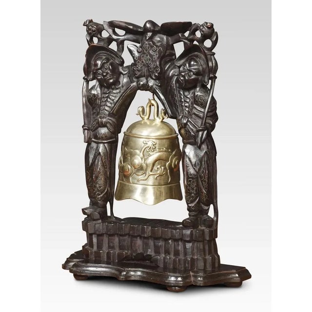 Oriental brass temple bell with heavily carved hardwood frame and ornate inlaid decoration supporting the original brass...