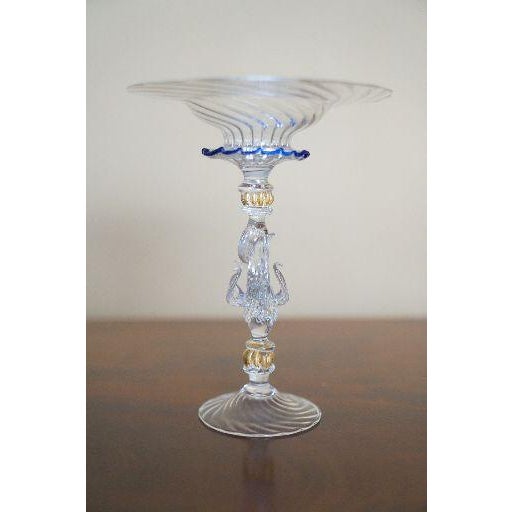 A delicate vintage Venetian Murano-style art glass compote featuring a ribbed flared bowl, applied cobalt-blue ruffled...