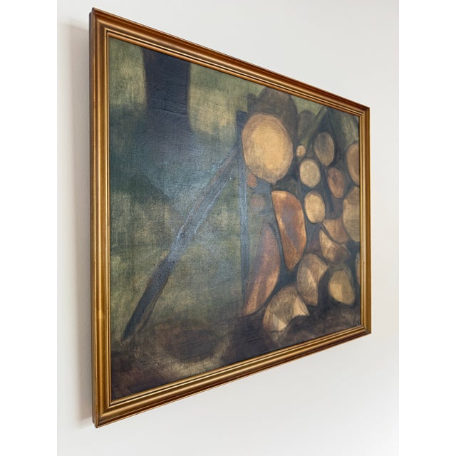 This is a Swedish still life with wood pile oil on canvas painting in its original gold frame. Signed on Verso “Bodil...