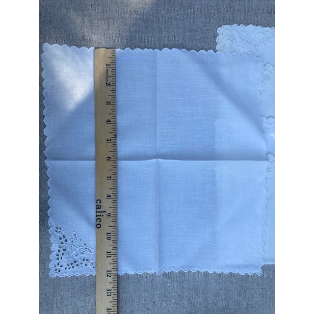 A set of 5 white on white linen napkins embroidered with a butterfly motif, starched,pressed and ready to serve.