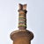 This finely carved wooden headrest comes from the Nyamwezi people of central Tanzania. Traditionally, headrests serve both...
