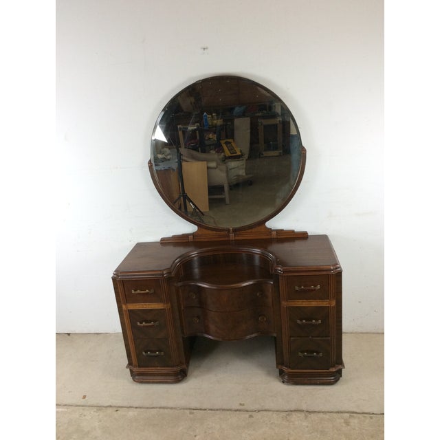 This Art Deco vanity features hardwood construction, original walnut finish, 8 dovetailed drawers with bakelite & brass...