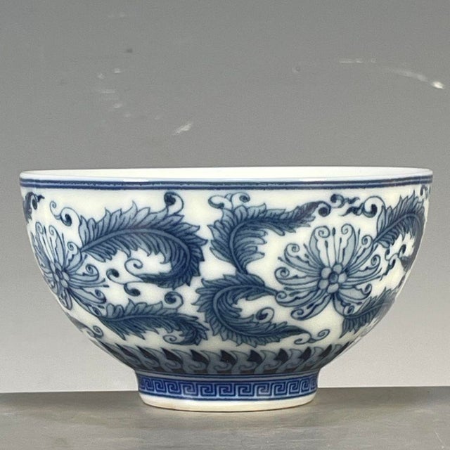 This is a charming vintage porcelain teacup, decorated in the classic blue and white (青花) palette. The cup features a...