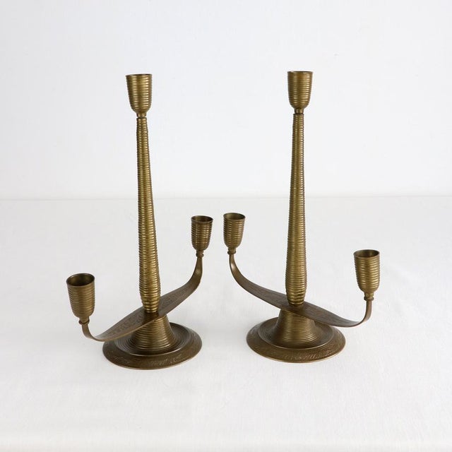 A stunning pair of three-light candelabras crafted from solid brass, a perfect example of mid-century Italian decorative...