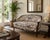 An exceptionally charming French Louis XV style settee with graceful curves, richly carved walnut framing, and fresh...