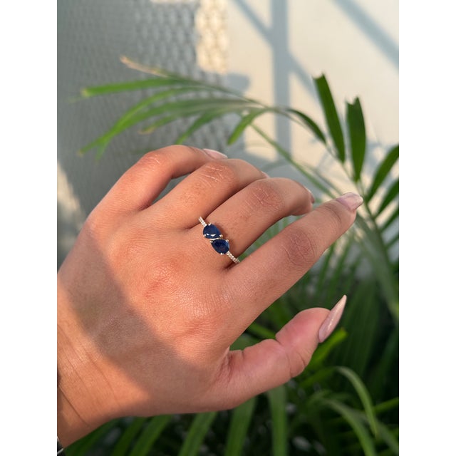 This Toi et Moi ring features a 1.45 carat Pear cut natural blue sapphire, set in 14K yellow gold. Each sapphire measuring...