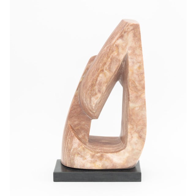 Modernist Abstract Pink Marble Sculpture, mounted on black marble base. Overall: 20.5" H x 11.5" W x 6" D. Provenance:...