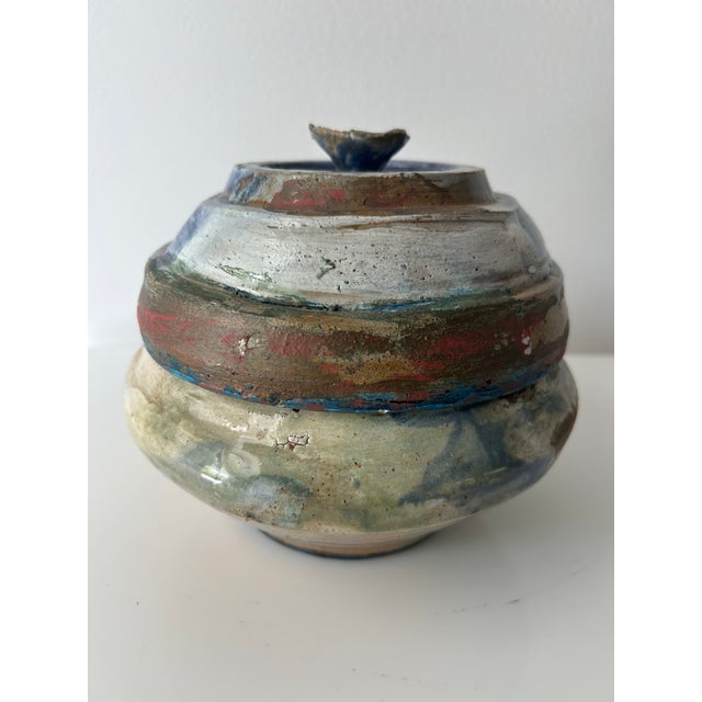 Vintage studio pottery vessel with lid. Beautiful handmade piece with blue, brown, burnt sienna and white glazes. Glaze is...