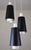 A three-light pendant designed by bent karlby for lyfa, denmark, representing the clean architectural character of...