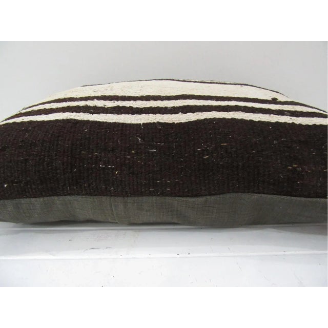 This is a pillow cover made from a vintage kilim rug. The piece was properly washed and ready to use. Pillow inserts not...