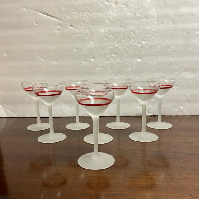 Very attractive set of eight small cordial cocktail glasses. They have a transparent top band and a red stripe then...