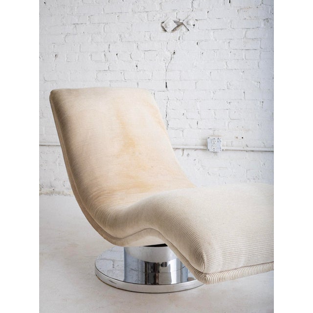 Mid-century chaise lounge rocker in ribbed cream upholstery on a chrome rocking swivel base. Designed by Milo Baughman for...