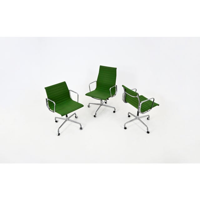 Set of three green fabric armchairs with aluminum bases and casters. They swivel. dimensions of the two smaller armchairs:...