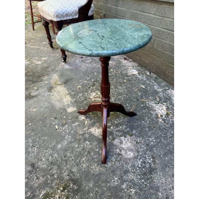 Vintage Bombay Company Green Marble Plant Stand. It features circular green marble top on a turned mahogany pedestal stand...