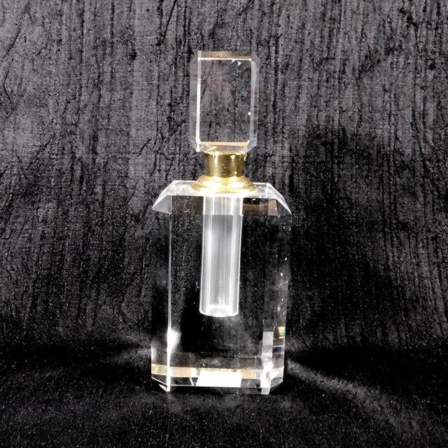 This is a large faceted cut crystal perfume bottle with a matching screw in stopper. The bottle and stopper are both cut...