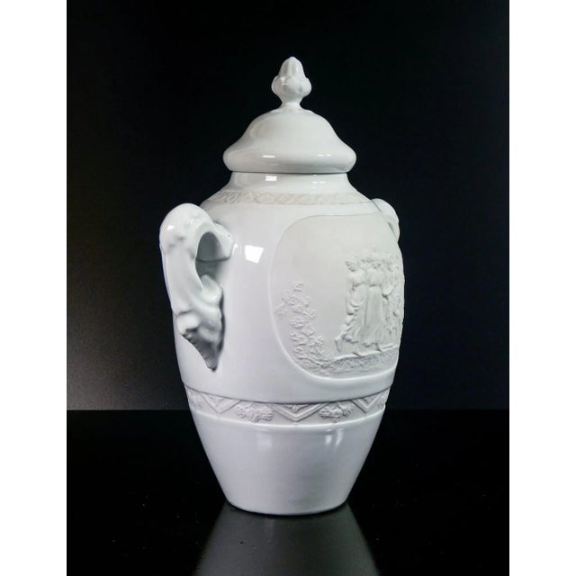 Limoges vase in biscuit ceramic and enamel, with classic style bas -reliefs. Origin france second twentieth century...