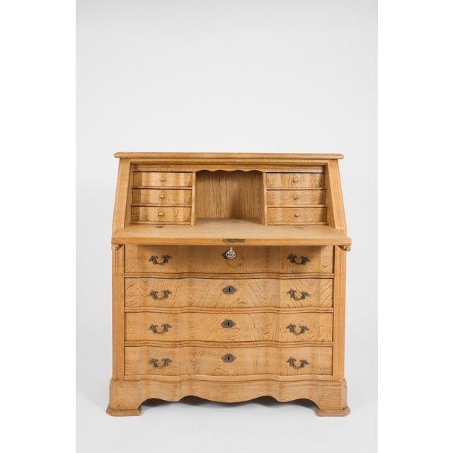 The upper section is fitted with symmetrically arranged drawers, creating a harmonious and architectural layout. Below, a...