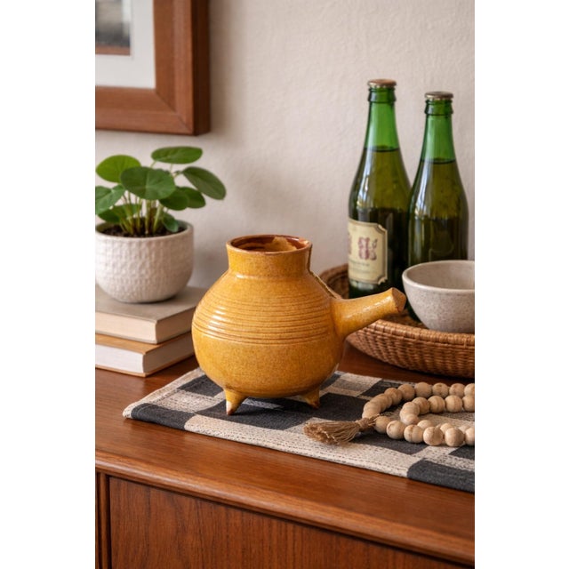 A beautifully sculptural mid-century Danish studio pottery vessel from Odense, featuring a distinctive tripod form with an...