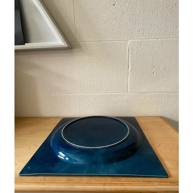 Square blue-glazed ceramic plate, Italy, 1970s Square ceramic plate featuring a deep, uniform blue glaze. Carefully...