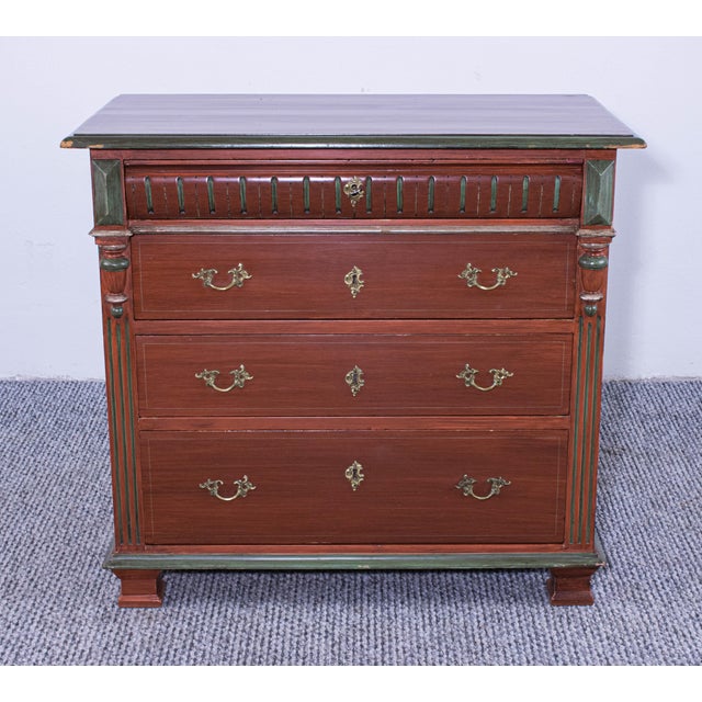 This antique pine chest of drawers features a rich, warm finish with elegant brass hardware. Its classic design is...