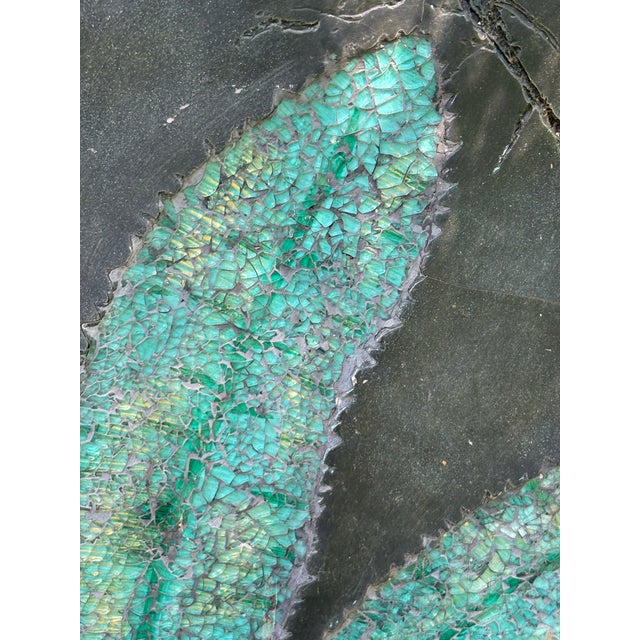 Large wall sculpture features a teal leaf crafted from crushed glass on and-textured resin designed to resemble natural...