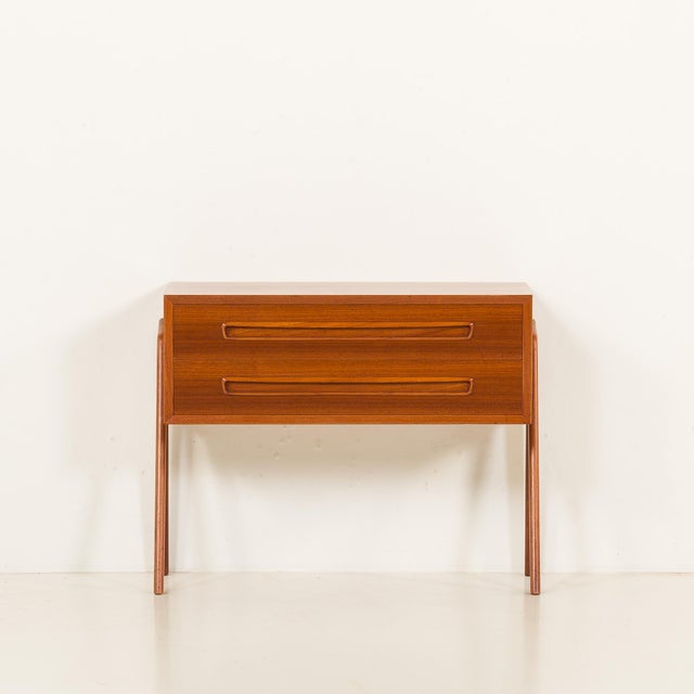 This petite danish teak dresser was made by svenstrup møbler in denmark in the 1960s. Its compact proportions and...