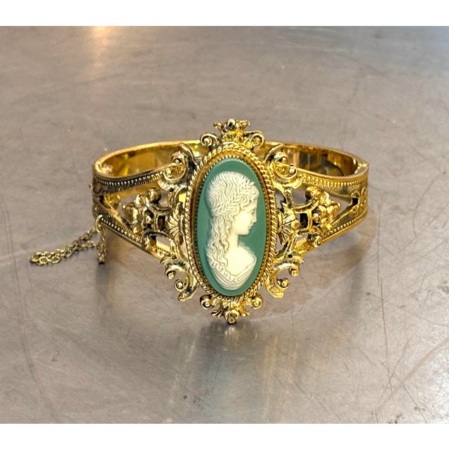 1940s-50s Whiting & Davis gold-tone bangle bracelet/cuff with teal & ivory colored cameo detail. Marked at back of cameo...