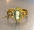 1940s-50s Whiting & Davis gold-tone bangle bracelet/cuff with teal & ivory colored cameo detail. Marked at back of cameo...