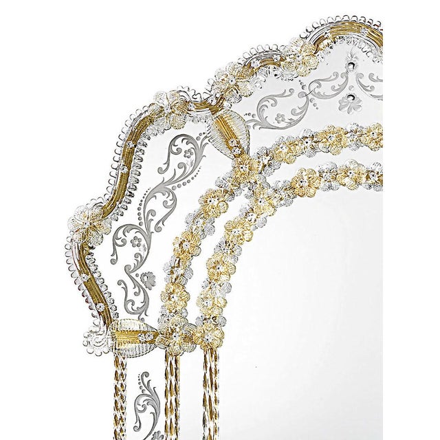 Handcrafted in Italy, this Venetian wall mirror features a graceful arched silhouette accented with hand-engraved...